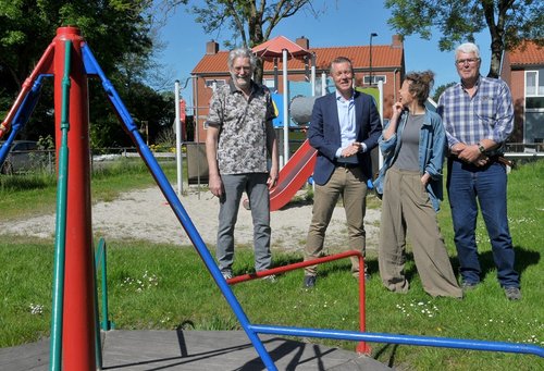 Foto burgemeester en inwoners in speeltuin